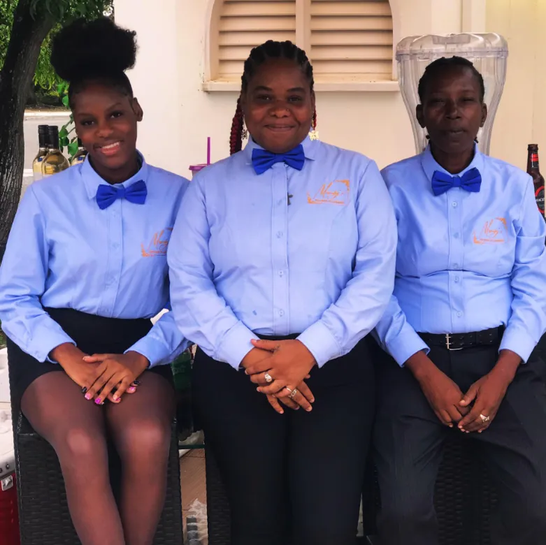 Three members of Mandy's event staff in branded light blue shirts and blue bow ties